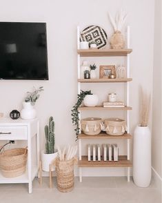 a living room filled with furniture and a flat screen tv mounted to the side of a wall