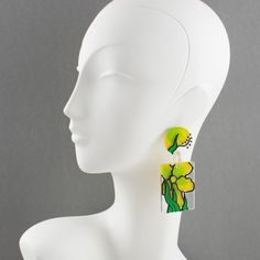 Stunning oversized "Flower Power" style Lucite pierced earrings. Features geometric dangling elements in crystal clear Lucite topped with hand-made floral enameled design in bright green, yellow, and black colors. For pierced ears. No visible maker's mark. Measurements: 1.44 in wide (3.7 cm) x 3.44 in high (8.8 cm).  Please see the measurements noted above in the description for the best approximate dimensions. Bold Green Earrings For Gifts, Bold Green Earrings For Gift, Vibrant Green Dangle Earrings, Bold Yellow Drop Earrings, Hand Painted Green Modern Jewelry, Modern Hand Painted Green Jewelry, Artistic Green Drop Earrings, Flower Power Fashion, Yellow And Green