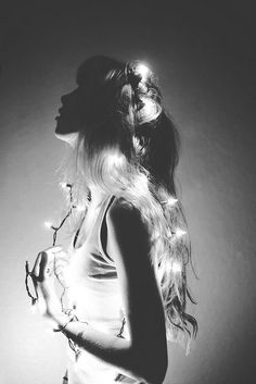 black and white photograph of a woman with lights in her hair