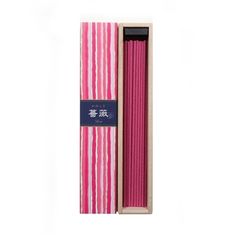 pink and white striped candles in a wooden box with chinese writing on the front side