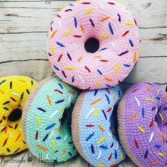 several knitted donuts with sprinkles are stacked on top of each other