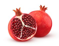 two pomegranates cut in half on a white background