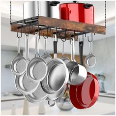 pots and pans hanging from a rack in a kitchen