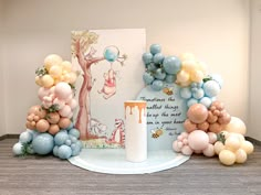 balloons and decorations on a table with winnie the pooh birthday card in front of it