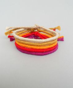 multicolored bracelets with tassels on white background