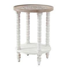 a white table with wooden legs and a round top on the bottom is an ornate design