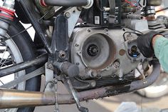 a close up of a motor bike with a person working on it's engine