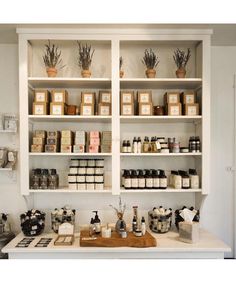 the shelves in this kitchen are filled with different types of spices and condiments