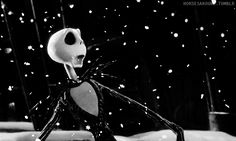 a black and white photo of a jack skellingy figure in the snow with lights on