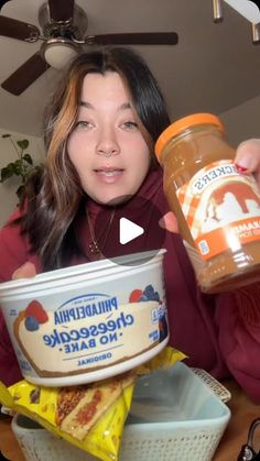 a woman holding a jar of cheesecake no - bake