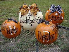 three pumpkins with the names of some kind on them