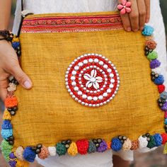 "This Crossbody Bag is made with hemp fabric and vintage Hmong hill tribe embroidery. It comes with adjustable strap. It has a zip opening, 1 zipper pocket inside and colorful pom pom decorations really makes it stand out. Pair this crossbody with something equally as chic and you'll cause fashion envy everywhere you go. We buy materials from Hmong market and we design and sew by hand. Some of the bags we modify to improve the product. The Hmong tribes live in the North of Thailand and have orig Hand Embroidered Jewelry, Pom Pom Decorations, Knitting Bag Pattern, Potli Bags, Embroidery Bags, Hand Embroidery Flowers, Diy Crafts Paper Flowers, Hemp Fabric, Tote Bags Handmade