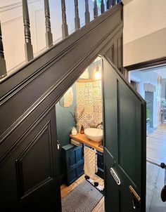 an open door leading to a bathroom with a sink