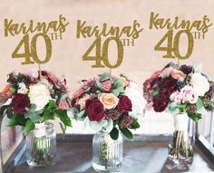 three vases filled with flowers on top of a table