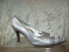 Stunning silver evening pumps. Size 7 1/2. Fabric uppers. Leather lining and sole.  3 1/4" covered heel.  The toes are embroidered in a geometric design in pewter, silver and white with sparkly square rhinestones. They have been worn once or twice and have a few light surface scuffs. Light sole wear. The inside heel area shows some darkening also the foot bead shows some wear.  I ship same or next business day. Silver Fitted Heels For Wedding, Gray Fitted Heels For Evening, Fitted Gray Heels For Evening, Silver Glamorous Wedding Shoes, Silver Glamorous Fitted Wedding Shoes, Metallic Silver Pointed Toe Heels For Wedding, Fitted Silver Wedding Shoes With 4-inch Heel, Fitted Silver Embellished Wedding Shoes, Silver Fitted Embellished Wedding Shoes