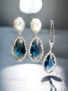 "Sapphire Bridal Earrings Crystal Bridal Earrings Blue Sapphire Wedding Earrings Bridal Jewelry Bridesmaids Earrings Sapphire Navy Earrings Add a touch of elegance to your bridal look with these Sapphire Bridal Earrings. These stunning earrings feature blue sapphire crystals that will add a pop of color to your wedding day ensemble. Crystal Glamour: These earrings are designed with sparkling blue sapphire crystals that will add brilliance and glamour to your look. Bridal Perfection: Perfect for Sapphire Jewelry Sets For Wedding, Sapphire Dangle Jewelry For Wedding, Sapphire Earrings For Wedding, Sapphire Jewelry For Party With Pierced Ears, Blue Wedding Jewelry With Matching Earrings, Blue Teardrop Earrings For Wedding, Elegant Blue Crystal Earrings For Wedding, Blue Crystal Dangle Bridal Earrings, Blue Jewelry With Matching Earrings For Bridesmaid Gift