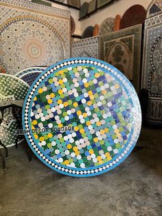 a colorful plate sitting on top of a table in a room filled with tables and chairs