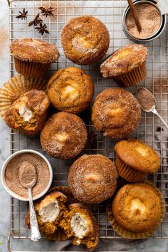 muffins on a cooling rack with powdered sugar and cinnamon