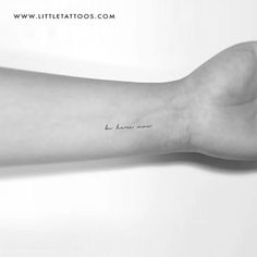 a person's arm with a small tattoo on the left side of their arm