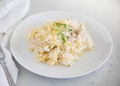 a white plate topped with rice and meat