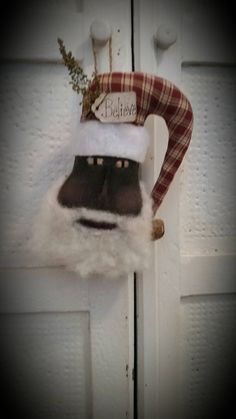 a santa clause hat hanging on the side of a door