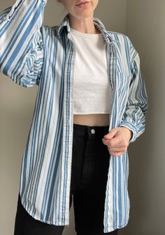 "100% cotton 90s striped button down. Great to wear open as a layering piece or tucked in. Tag is Teez Me in the best 90s font and graphic. If you're looking for a classic layer or button down for your closet, this is it! Labeled men's medium, best for unisex small to large depending on desired fit. Measurements (laying flat) PTP 18\" Length 27.5\" This is a vintage piece, please handle with care." Cotton Button-up Tops With Vertical Stripes, 90s Style Relaxed Fit Button-up Top, 90s Style Cotton Button-up Shirt, 90s Style Cotton Shirt For Spring, 90s Style Cotton Shirt With Buttons, Vintage Shirt For Everyday Spring Wear, Striped Cotton Button-up Tops, Oversized 90s Inspired Tops For Spring, 90s Style Cotton Tops With Button Closure