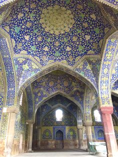 the inside of an ornate building with blue and green tiles on it's walls