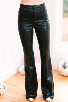 You are not going to want to walk away from these pants! They are everything! They are super sassy with faux leather leather fabric and trendy flared leg! These zip front pants are going to pair with cozy sweaters and feminine blouses! These pants features a faux leather fabric, button/zip front closure, pintuck detailing, and a flared leg. Material has a fair amount of stretch.Cam is wearing the small. Flare Leather Pants, Black Faux Leather Pants, Feminine Blouses, Floral Cocktail Dress, Sales Tips, Black Tie Dress, Long Sleeve Outerwear, Two Piece Swimwear, Pants Large