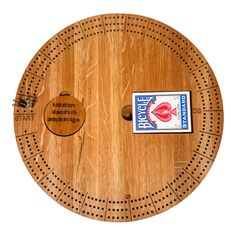 a round wooden table with two fish on it and a sticker in the middle