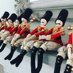 many toy soldiers are lined up on the ledge in front of a mirror with gold trimmings