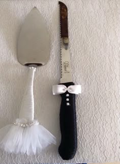 a knife with a tulle attached to it next to a black handled spatula