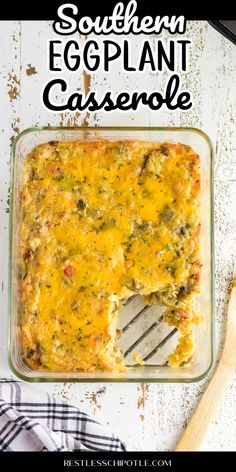 an eggplant casserole in a glass dish with a spatula