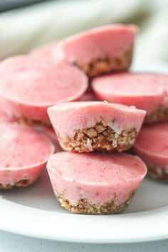 some pink desserts are on a white plate