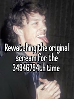 a man in a suit laughing with the caption saying rewatching the original scream for