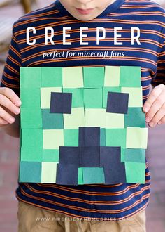 a young boy holding up a piece of paper with the words creeper on it