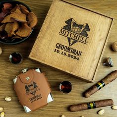 a wooden box filled with lots of different types of cigars and other items on top of a table