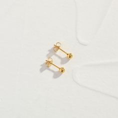 Introducing our Little Stud Earrings, a charming addition to your jewelry collection. These dainty earrings feature a classic design crafted with care. With their versatile style and understated charm, they're perfect for everyday wear. When you're not wearing this piece, tuck it away in your very own Milou jewellery box provided. Stainless Steel, plated with 18K Gold Waterproof (Tarnish Resistant) Natural Linen Milou Jewellery Box Included FREE WORLDWIDE SHIPPING Classic Drop Cartilage Earrings, Classic Drop Cartilage Earrings With Matching Set, Classic Tarnish Resistant Cartilage Earrings As Gift, Classic Hypoallergenic Nose Studs Gift, Tiny Round Elegant Cartilage Earrings, Classic Hypoallergenic Piercings For Gift, Elegant Tiny Round Nose Studs, Classic Yellow Gold Piercings As Gift, Classic Yellow Gold Piercings For Gifts