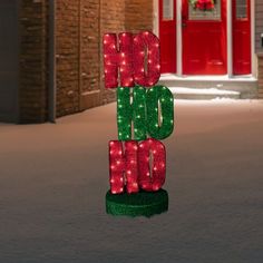 a lighted sign in the middle of a street that says hope, love, and christmas