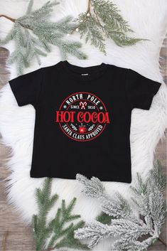 Stay cozy through the winter season with these North Pole Hot Cocoa Shirts! Highly recommended by Santa himself, this yummy hot cocoa design will keep the Christmas spirit alive. Get one for yourself or for your favorite cocoa-lover today! Short Sleeve Bodysuit, North Pole, Stay Cozy, Hot Cocoa, Winter Season, Christmas Spirit, The Christmas, The Winter, Get One