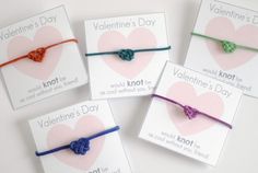 four valentine's day bracelets with hearts on them, tied together in different colors