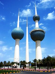 two tall white towers with blue sky in the background