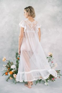 "Vintage 60s Cream Peignoir Bridal Wedding Lingerie Dress Embroidered Beaded M Ties at the neck -Measurements- Estimated Size: Medium Bust: 36\" Waist : free Hips: free Length: 42\" Sleeve: 4\" Model is 5'9 and measures 32/25/34" Fitted Sheer Robe For Wedding, Vintage Wedding Nightgown With Delicate Lace, Sheer Lace Wedding Robe, Fitted Lace Trim Nightgown For Wedding, Sheer Nightgown For Wedding, Feminine Wedding Nightgown With Lace Trim, Vintage White Wedding Robe, Delicate Lace Nightgown For Weddings, Delicate Lace Wedding Nightgown