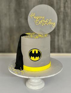 a birthday cake decorated with a batman symbol