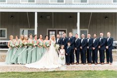 a group of people standing next to each other in front of a building