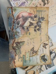 an altered collage with butterflies and other things on top of it, including paper