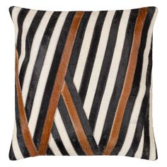 a black and white striped pillow with brown leather strips on the front, along with an orange strip across the back