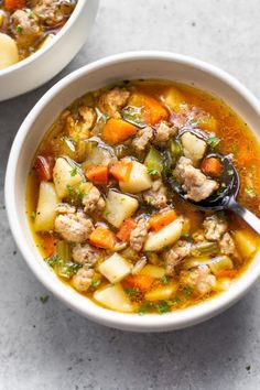 two bowls of soup with meat and vegetables