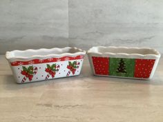 two christmas themed dishes sitting on top of a counter