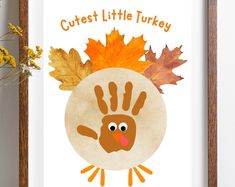 a turkey handprint with leaves on it and the words cutest little turkey above it