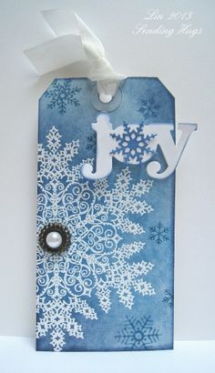 a tag with snowflakes on it that says joy